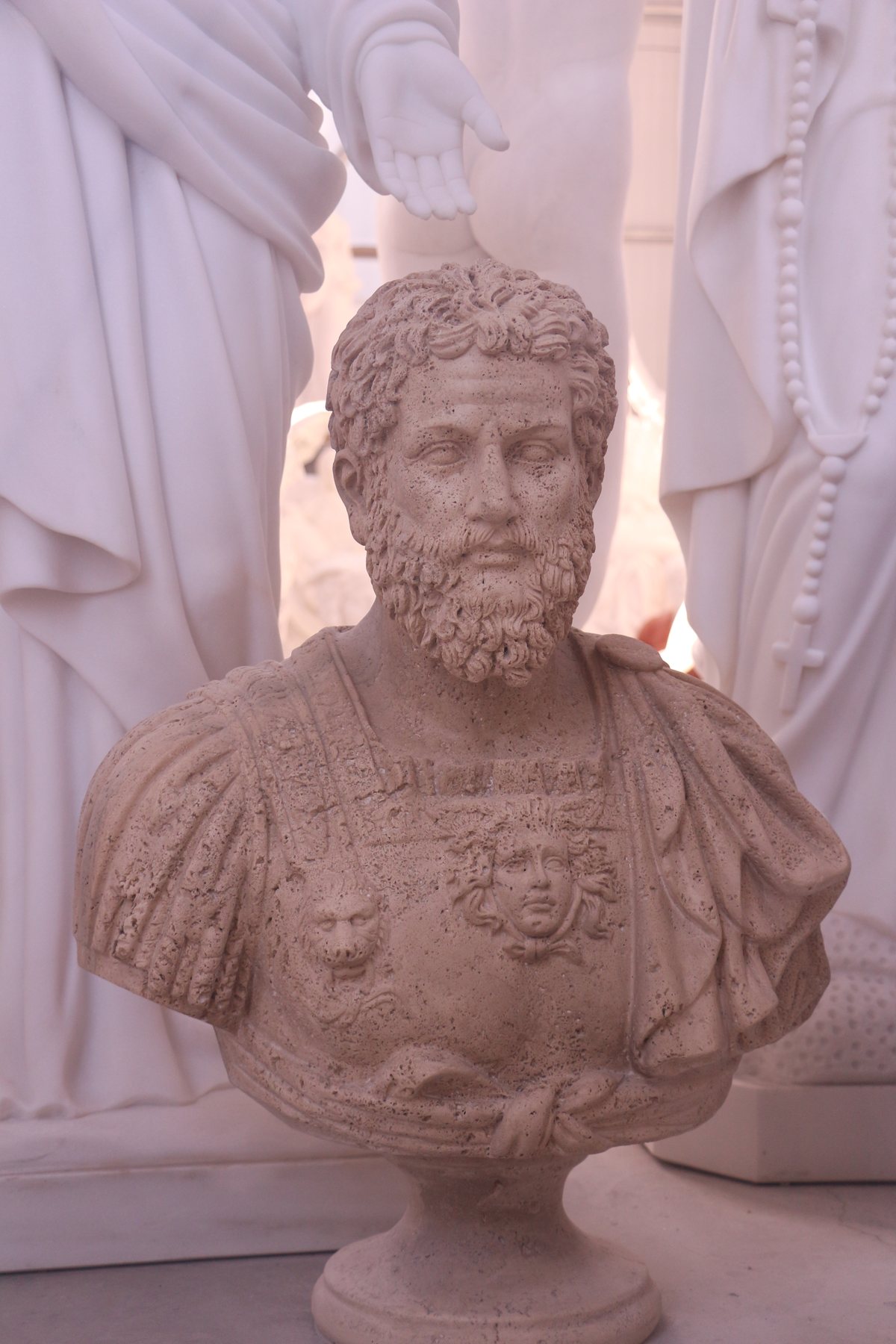 Carved bust of a bearded Roman emperor in decorated armour, photographed at our production partner's workshop