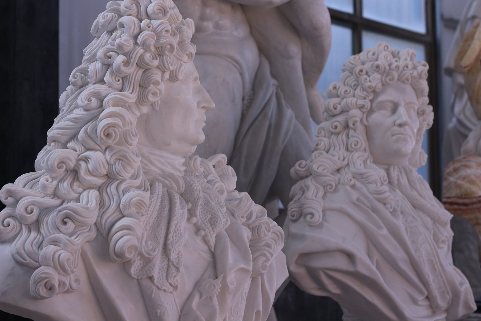 White marble portrait busts with carved curled hair and drapery, photographed at our production partner's workshop